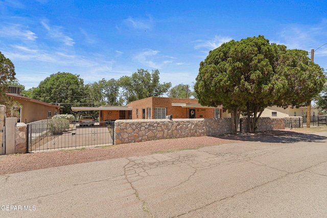 211 Green Haven Pl, El Paso, TX 79907 - view of front of property with a fenced front yard, a gate, a carport, and brick siding