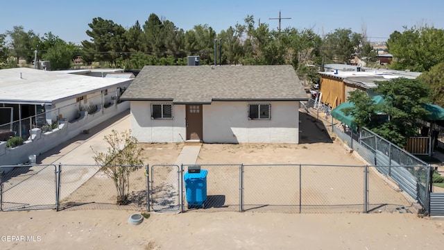 729 Delhi Dr, Socorro, TX 79927 - view of front facade with stucco siding, a gate, and roof with shingles