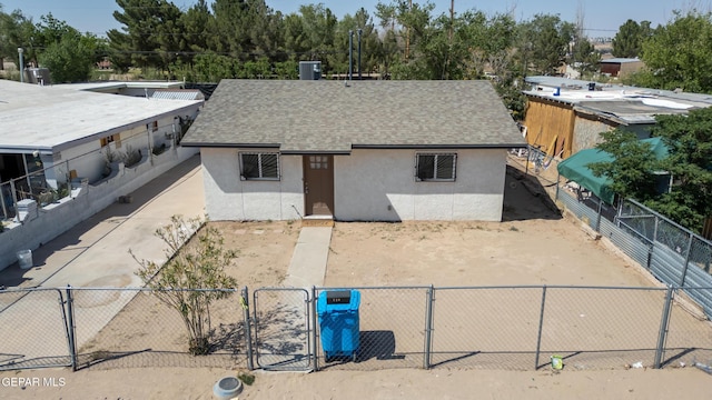 729 Delhi Dr, Socorro, TX 79927 - view of front facade featuring stucco siding, a gate, and a shingled roof