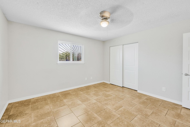 729 Delhi Dr, Socorro, TX 79927 - unfurnished bedroom featuring baseboards, a closet, a textured ceiling, and a ceiling fan
