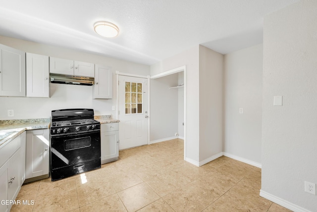 729 Delhi Dr, Socorro, TX 79927 - kitchen with black range with gas stovetop, under cabinet range hood, light tile patterned floors, and light stone countertops