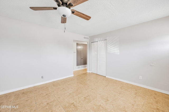729 Delhi Dr, Socorro, TX 79927 - unfurnished bedroom with a textured ceiling, tile patterned flooring, baseboards, and a ceiling fan