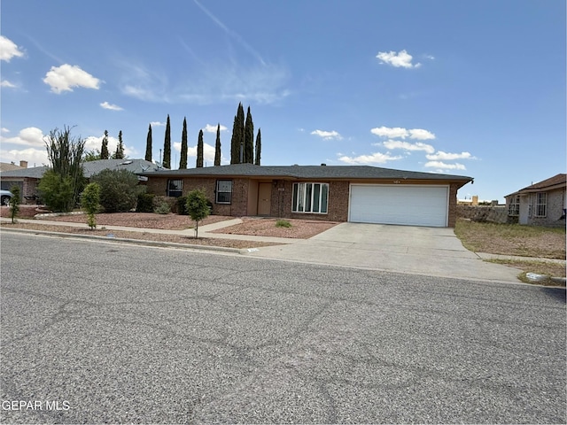 3224 Seabrook St, El Paso, TX 79936 - view of front facade with an attached garage, driveway, and brick siding