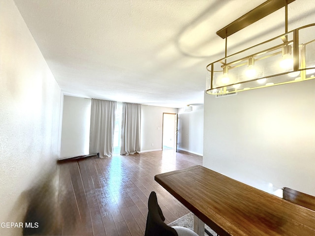 3224 Seabrook St, El Paso, TX 79936 - unfurnished dining area featuring dark wood-style floors and baseboards