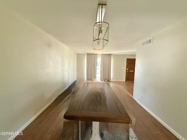 3224 Seabrook St, El Paso, TX 79936 - unfurnished dining area with baseboards, wood finished floors, and a chandelier
