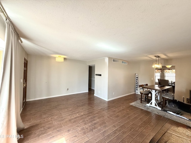 3224 Seabrook St, El Paso, TX 79936 - dining space with a textured ceiling, dark wood-style flooring, and baseboards