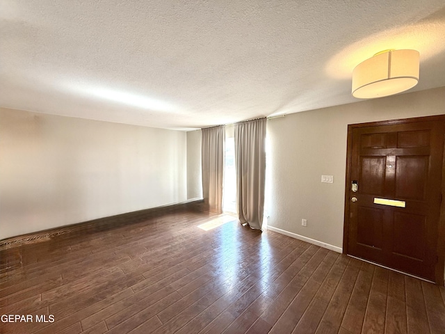 3224 Seabrook St, El Paso, TX 79936 - spare room featuring a textured ceiling, baseboards, and dark wood-style flooring