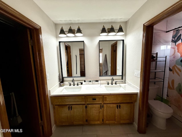 3224 Seabrook St, El Paso, TX 79936 - bathroom with double vanity, curtained shower, tile patterned flooring, toilet, and a textured wall