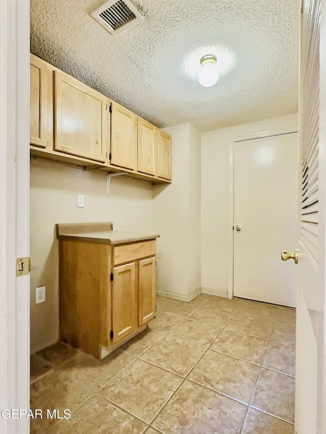 549 Northwyck Way, El Paso, TX 79928 - washroom with a textured ceiling and light tile patterned flooring