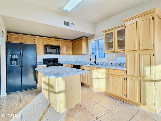 549 Northwyck Way, El Paso, TX 79928 - kitchen with black appliances, light brown cabinets, a sink, and a center island