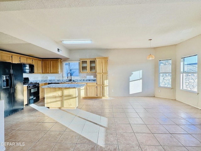 549 Northwyck Way, El Paso, TX 79928 - kitchen with black appliances, light countertops, light tile patterned floors, a sink, and a center island