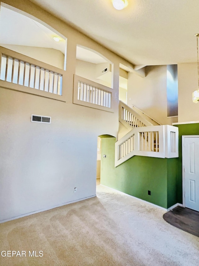549 Northwyck Way, El Paso, TX 79928 - unfurnished living room featuring a high ceiling, carpet floors, arched walkways, and baseboards