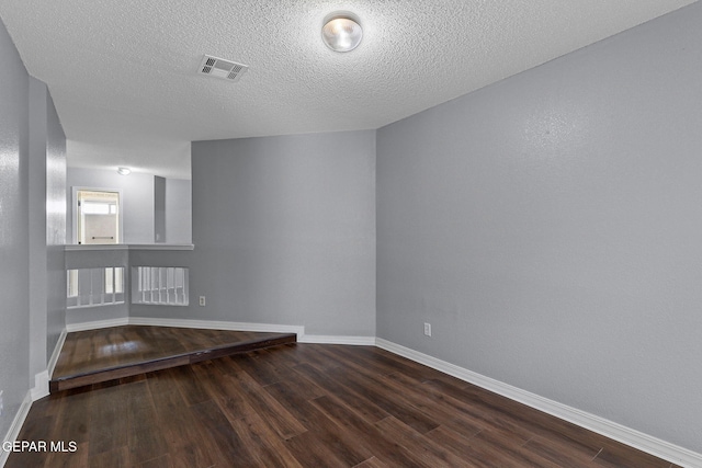 1461 Luz De Luna Pl, El Paso, TX 79912 - unfurnished room featuring wood finished floors, baseboards, and a textured ceiling