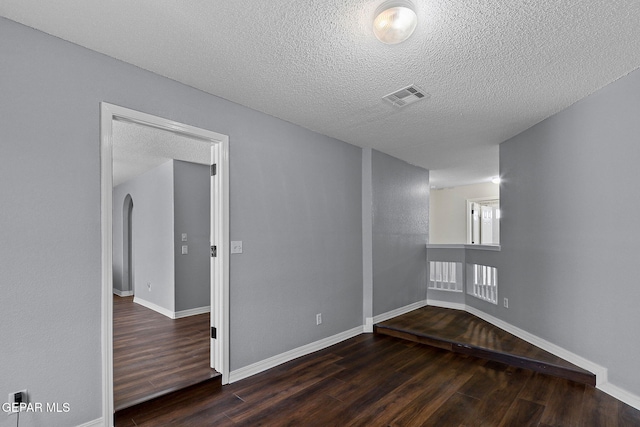 1461 Luz De Luna Pl, El Paso, TX 79912 - unfurnished room with wood finished floors, a textured ceiling, baseboards, and arched walkways