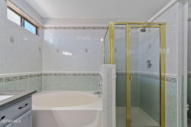 1461 Luz De Luna Pl, El Paso, TX 79912 - bathroom with tile walls, a garden tub, vanity, and a shower stall