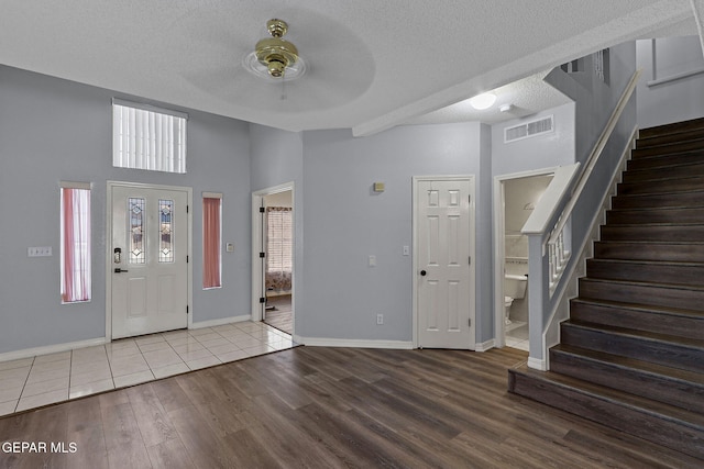 1461 Luz De Luna Pl, El Paso, TX 79912 - foyer featuring wood finished floors, ceiling fan, stairway, a textured ceiling, and plenty of natural light