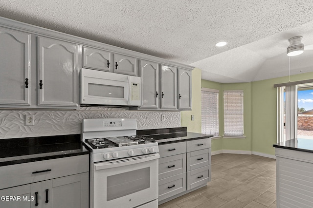1461 Luz De Luna Pl, El Paso, TX 79912 - kitchen featuring white appliances, a textured ceiling, dark countertops, baseboards, and recessed lighting