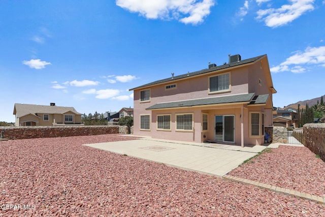 1461 Luz De Luna Pl, El Paso, TX 79912 - rear view of property with stucco siding, a patio area, a fenced backyard, central AC, and a gate