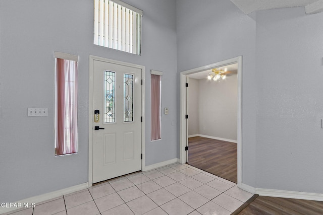 1461 Luz De Luna Pl, El Paso, TX 79912 - entryway featuring baseboards, a towering ceiling, and light wood finished floors