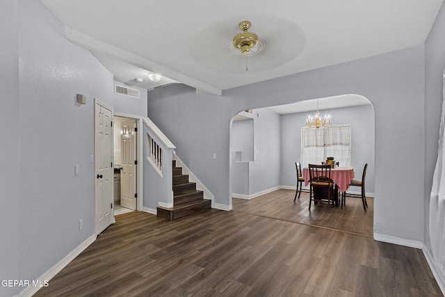 1461 Luz De Luna Pl, El Paso, TX 79912 - dining space with arched walkways, stairs, dark wood-style flooring, and a chandelier