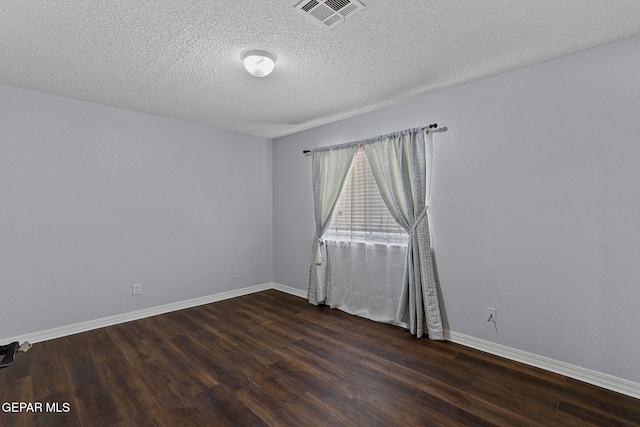 1461 Luz De Luna Pl, El Paso, TX 79912 - spare room featuring dark wood-type flooring, baseboards, and a textured ceiling