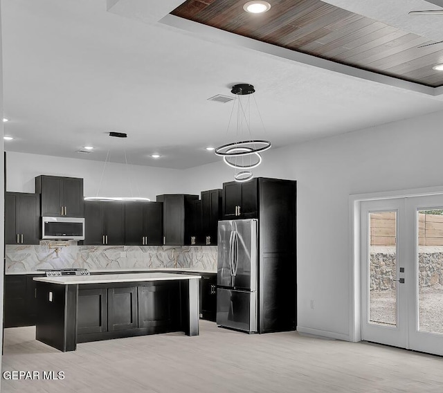 12036 Cotton Cloud Way, Socorro, TX 79927 - kitchen featuring stainless steel appliances, light countertops, dark cabinetry, and recessed lighting