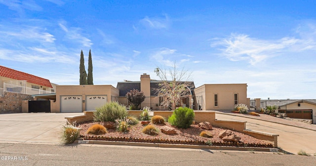 1428 Camino Alto Rd, El Paso, TX 79902 - southwest-style home featuring driveway and a garage