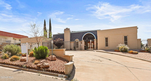 1428 Camino Alto Rd, El Paso, TX 79902 - view of front of home with brick siding and a chimney