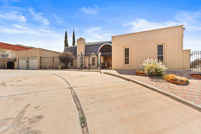 1428 Camino Alto Rd, El Paso, TX 79902 - view of front of property with brick siding, concrete driveway, and a garage