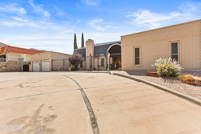 1428 Camino Alto Rd, El Paso, TX 79902 - view of front of house featuring concrete driveway, brick siding, and a garage