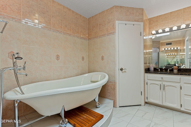 1428 Camino Alto Rd, El Paso, TX 79902 - full bathroom featuring tile walls, vanity, and a soaking tub