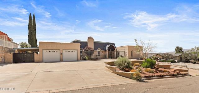 1428 Camino Alto Rd, El Paso, TX 79902 - view of front of house with a garage, concrete driveway, and a gate