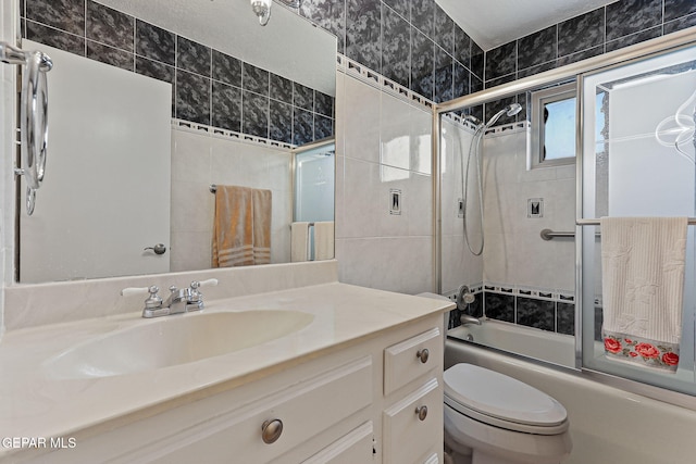 1428 Camino Alto Rd, El Paso, TX 79902 - full bath featuring vanity, combined bath / shower with glass door, toilet, and tile walls