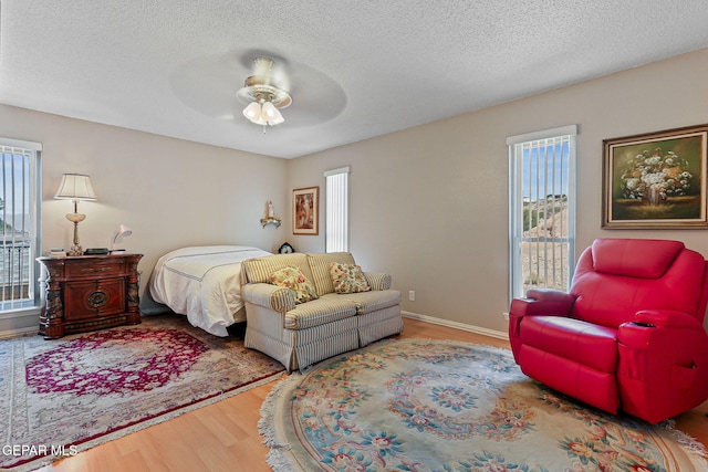 1428 Camino Alto Rd, El Paso, TX 79902 - bedroom featuring wood finished floors, a textured ceiling, and a ceiling fan