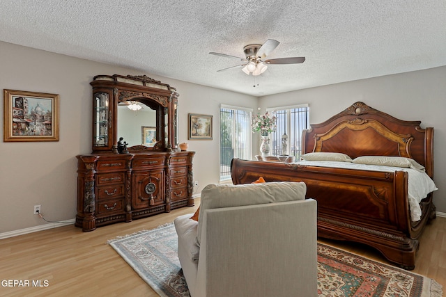 1428 Camino Alto Rd, El Paso, TX 79902 - bedroom with access to outside, light wood-type flooring, a textured ceiling, baseboards, and a ceiling fan