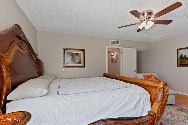 1428 Camino Alto Rd, El Paso, TX 79902 - bedroom with a textured ceiling, a ceiling fan, wood finished floors, and baseboards