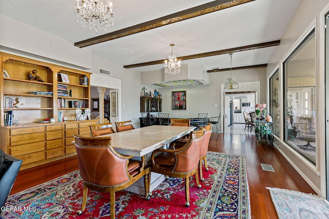 1428 Camino Alto Rd, El Paso, TX 79902 - dining area featuring a chandelier, ornate columns, beamed ceiling, dark wood finished floors, and a textured ceiling