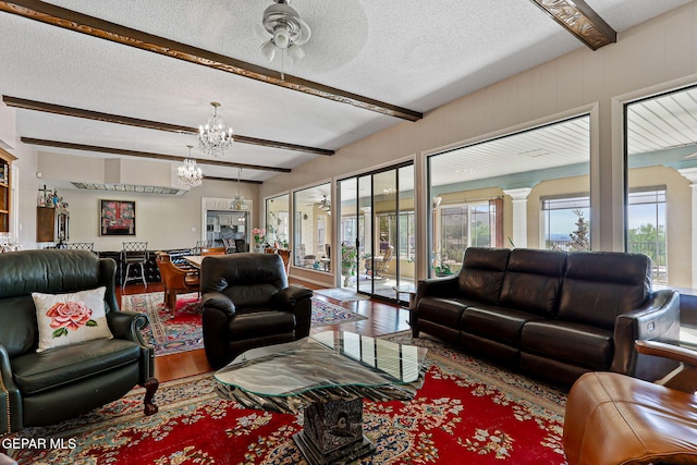 1428 Camino Alto Rd, El Paso, TX 79902 - living room with a chandelier, wood finished floors, beam ceiling, plenty of natural light, and a textured ceiling