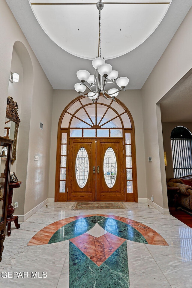 1428 Camino Alto Rd, El Paso, TX 79902 - entryway featuring inlaid floor details, a chandelier, baseboards, and plenty of natural light