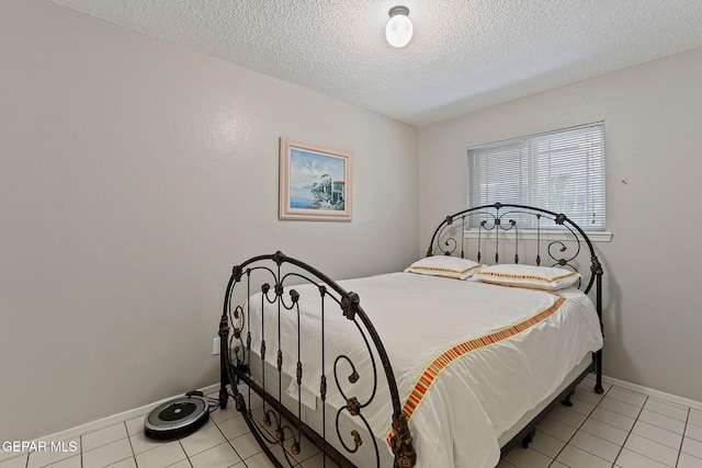 1428 Camino Alto Rd, El Paso, TX 79902 - bedroom with a textured ceiling, light tile patterned flooring, and baseboards