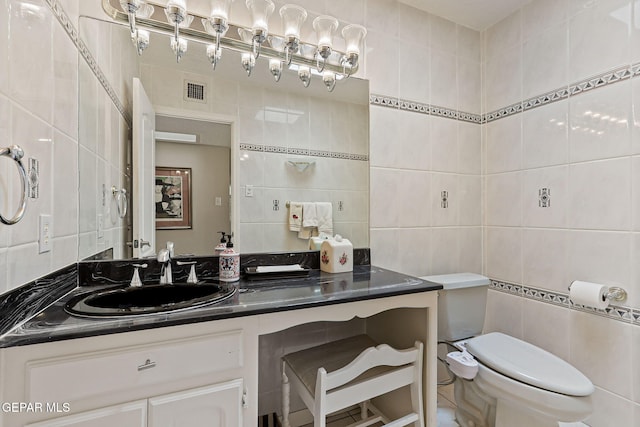 1428 Camino Alto Rd, El Paso, TX 79902 - bathroom featuring tile walls, vanity, toilet, and tasteful backsplash