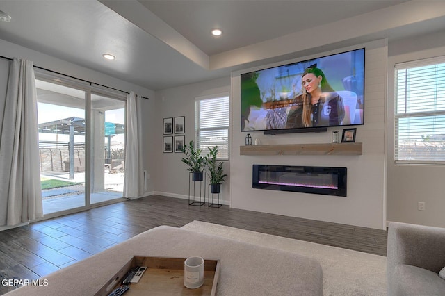 289 Hunstanton St, Horizon City, TX 79928 - living room featuring a glass covered fireplace, recessed lighting, wood finished floors, and baseboards