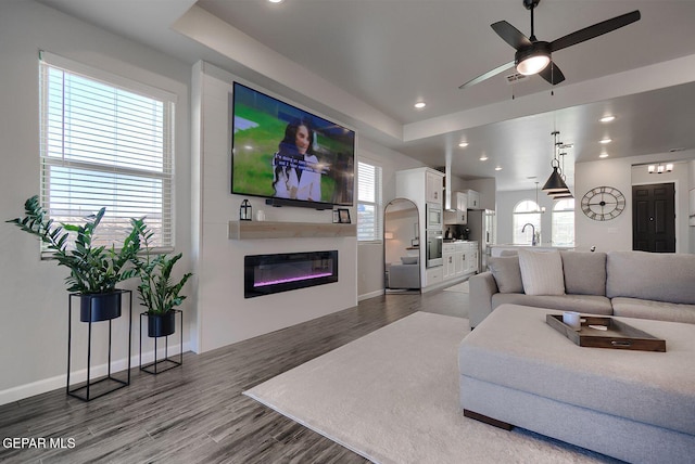 289 Hunstanton St, Horizon City, TX 79928 - living room featuring a glass covered fireplace, ceiling fan, wood finished floors, baseboards, and recessed lighting