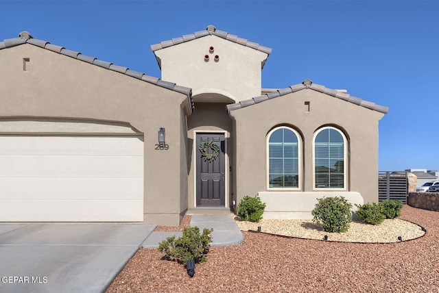 289 Hunstanton St, Horizon City, TX 79928 - mediterranean / spanish-style house with an attached garage, concrete driveway, and stucco siding