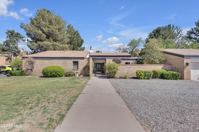 724 Gary Ln, El Paso, TX 79922 - view of front facade with brick siding, a chimney, a gate, and a garage