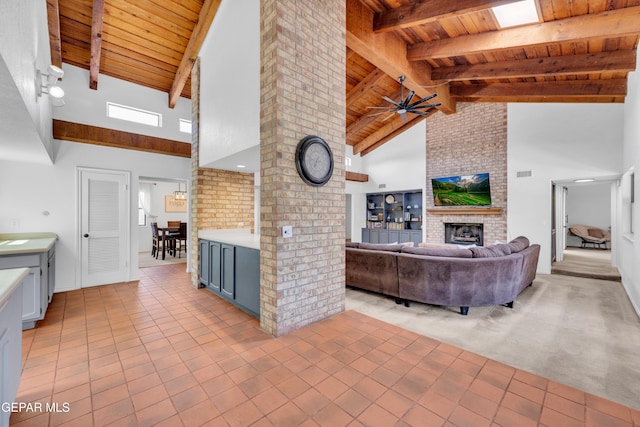 724 Gary Ln, El Paso, TX 79922 - living room with wooden ceiling with exposed beams, light tile patterned flooring, a brick fireplace, a ceiling fan, and high vaulted ceiling