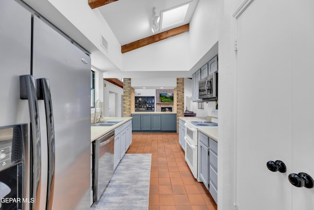 724 Gary Ln, El Paso, TX 79922 - kitchen featuring stainless steel appliances, a sink, light countertops, and ornate columns