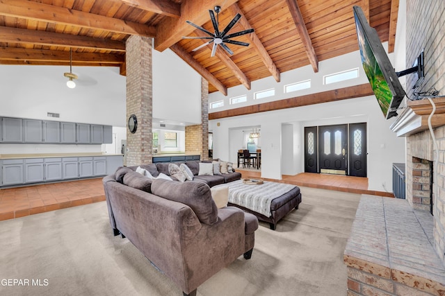 724 Gary Ln, El Paso, TX 79922 - living area featuring high vaulted ceiling, wood ceiling with exposed beams, ceiling fan, a fireplace, and light colored carpet