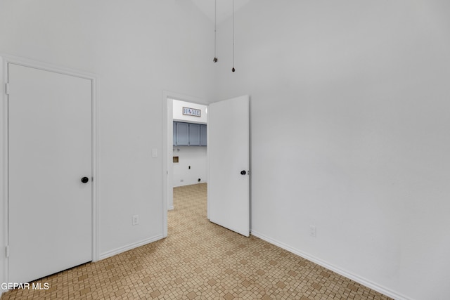 724 Gary Ln, El Paso, TX 79922 - unfurnished bedroom with baseboards and a towering ceiling