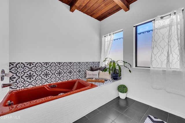 724 Gary Ln, El Paso, TX 79922 - bathroom with wood ceiling, tile patterned flooring, a bath, and baseboards